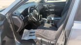 Interior of a car viewed from the driver's side, showing the steering wheel, dashboard, and front seats.